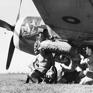 Four ground crew of No. 134 Squadron RAF load a 500-lb GP bomb