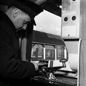 A guard at the controls of one of London Underground