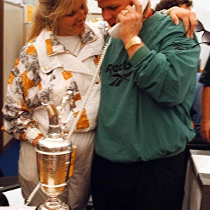 John Daly phones home to his parents in the USA watched by his wife Paulette after