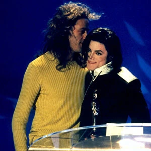 Michael Jackson accepts his award from Bob Geldof at the 1996 Brit Awards