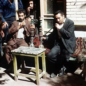 Shiraz South West Iran Persians smoking hubble bubble pipes at a cafe