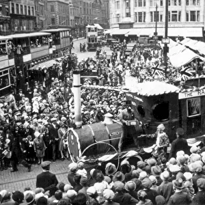 A Trent Motor Traction Company tableau movers through the crowds in Derby Market Place