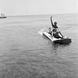 Woman enjoys a trip on a speedboat during a holiday on the French Riviera