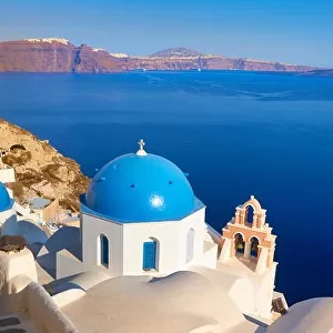 Santorini landscape with greek white church, bell tower and Aegean Sea in the background, Oia Town, Santorini Island, Greece