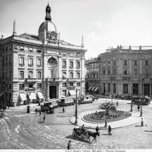 Piazza Cordusio in Milan. The Palace of the Insurances with its large niche surmounted by a small dome surrounds the elliptical Piazza
