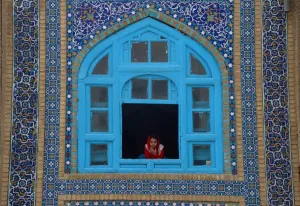 <b class=qtipBold><figcaption>Afghanistan-Festival-Nowruz</figcaption></b><br>An Afghan girl looks on a window of the Hazrat-e-Ali shrine at Nowruz festivities which mark the Afghan new year in Mazari-i-Sharif on March 21, 2017. Nowruz, one of the biggest festivals of the war-scarred nation, marks the first day of spring and the beginning of the year in the Persian calendar. Nowruz is calculated according to a solar calendar, this coming year marking 1396. / AFP PHOTO / FARSHAD USYAN<br><em>© Copyright Agence France-Presse (AFP) - All Rights Reserved</em> Afghanistan-Festival-Nowruz