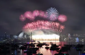 <b class=qtipBold><figcaption>Australia-New Year-Fireworks</figcaption></b><br>Fireworks light up the sky over Sydney's Opera House (L) and Harbour Bridge during New Year celebrations in Sydney on January 1, 2016. / AFP PHOTO / SAEED KHAN<br><em>© Copyright Agence France-Presse (AFP) - All Rights Reserved</em> Australia-New Year-Fireworks