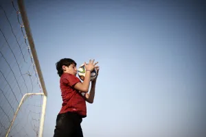Prints of A Bahraini boy catches a ball as he plays football in the village of Barbar, west of the capital Manama, on May 31, 2014. AFP PHOTO/MOHAMMED AL-SHAIKH (Photo by MOHAMMED AL-SHAIKH / AFP) Football Around The World Prints: Bahrain-Theme-Football