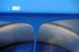 France Prints: Blue paint is poured into a bucket in a workshop at the Raphael-Isabey-Sennelier