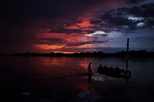 <b class=qtipBold><figcaption>Brazil-Pantanal-Feature</figcaption></b><br>A man wades through a lake at sunset in Pantanal, Mato Grosso, Brazil on March 7, 2018. / AFP PHOTO / CARL DE SOUZA<br><em>© Copyright Agence France-Presse (AFP) - All Rights Reserved</em> Brazil-Pantanal-Feature
