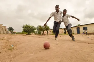 Children play football in the streets of the Kinsuka neighbourhood in the city of