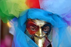 A costumed reveller poses near Saint Marks square during the carnival on February 21