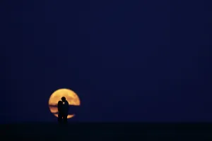 A couple kiss in front of the full moon in Burgos on September 9, 2014 A couple kiss in front of the full moon in Burgos on September 9, 2014