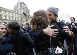 A couple kisses during a flashmob near the Louvre Pyramid in Paris on February 14 A couple kisses during a flashmob near the Louvre Pyramid in Paris on February 14