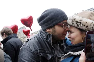 A couple takes a selfie with their mobile phone during a flashmob near A couple takes a selfie with their mobile phone during a flashmob near