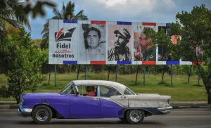 <b class=qtipBold><figcaption>Cuba-Castro-Classic Car</figcaption></b><br>An old car drives past a billboard depicting Cuban revolutionary leader Fidel Castro and reading Fidel Among us in Havana, on November 27, 2016. AFP PHOTO / Yamil LAGE<br><em>© Copyright Agence France-Presse (AFP) - All Rights Reserved</em> Cuba-Castro-Classic Car