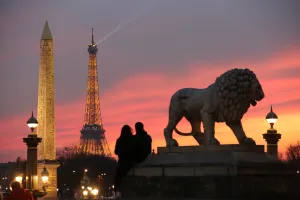 <b class=qtipBold><figcaption>France-Paris-Eiffel Tower</figcaption></b><br>This file photo taken on February 28, 2016 shows a couple sitting next to a lion statue and watching the Eiffel tower at sunset, near Place de la Concorde in Paris. / AFP PHOTO / LUDOVIC MARIN<br><em>© Copyright Agence France-Presse (AFP) - All Rights Reserved</em> France-Paris-Eiffel Tower