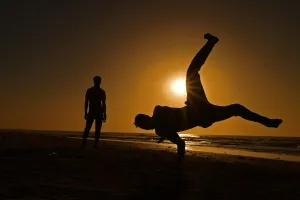 <b class=qtipBold><figcaption>Gambia-Tourism-Lifestyle</figcaption></b><br>Young men perform acrobatics on the beach in Serekunda outside Banjul. AFP PHOTO/Carl de Souza / AFP PHOTO / CARL DE SOUZA<br><em>© Copyright Agence France-Presse (AFP) - All Rights Reserved</em> Gambia-Tourism-Lifestyle