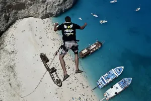 <b class=qtipBold><figcaption>Greece-Lifestyle-Leisure-Tourism</figcaption></b><br>Lukas Michul, a member of the 'dream walker' group jumps from atop the rugged rocks overlooking the azure waters of Navagio beach, one of the Greece's most renowned leisure spots on the popular tourist island of Zakynthos on June 23, 2014. This is rope jumping -- part diving, part rock climbing, with a touch of engineering. The aim of the project is to dream jump in 80 places with most ravishing nature and architecture all over the world .They plan to stage their next leaps at a cave complex in Croatia, a French viaduct, skyscrapers in Las Vegas and Johannesburg, and the Grand Canyon. AFP PHOTO / LOUISA GOULIAMAKI / AFP PHOTO / LOUISA GOULIAMAKI<br><em>© Copyright Agence France-Presse (AFP) - All Rights Reserved</em> Greece-Lifestyle-Leisure-Tourism