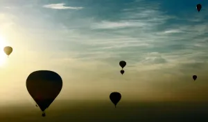 Hot-air balloons fly over buildings on the outskirts of Minsk on September 12, 2014 Hot-air balloons fly over buildings on the outskirts of Minsk on September 12, 2014