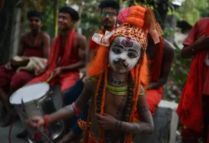 <b class=qtipBold><figcaption>India-Religion-Hinduism-Festival</figcaption></b><br>An Indian child dressed as the Hindu deity Shiva dances with others as they begs for alms in Siliguri on April 12, 2017, ahead of the 'Charak' ritual that is observed on the last day of the Bengali calender year. Hindu devotees offer various symbolic sacrifices hoping for the favour of Shiva to mark the advent of the Bengali new year, which falls on April 14. / AFP PHOTO / DIPTENDU DUTTA<br><em>© Copyright Agence France-Presse (AFP) - All Rights Reserved</em> India-Religion-Hinduism-Festival