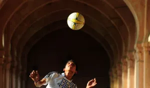 Prints of An Indian youth practices his football skills at the Allahabad University campus in Allahabad on June 10, 2014. AFP PHOTO/SANJAY KANOJIA (Photo by Sanjay Kanojia / AFP) Football Around The World Prints: India-Theme-Football