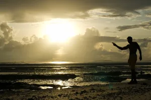 Africa Prints: A man gestures on a beach in Dar es Salaam on April 26, 2014, as Tanzania celebrates
