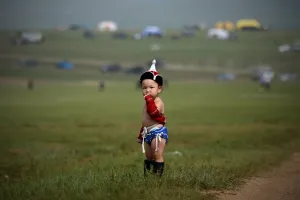 <b class=qtipBold><figcaption>Mongolia-Festival-Culture-Naadam</figcaption></b><br>A Mongolian baby clad in traditional wrestling attire looks on during the Mongolian summer festival known as Naadam on the outskirts of Ulan Bator on July 13, 2016. / AFP PHOTO / WANG ZHAO<br><em>© Copyright Agence France-Presse (AFP) - All Rights Reserved</em> Mongolia-Festival-Culture-Naadam