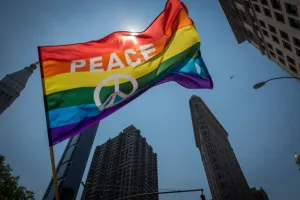 Prints of A participant waves a flag near the Flatiron Building during the 46th annual Gay Pride march June 26, 2016 in New York. AFP PHOTO / the 46th / Bryan R. Smith USA Prints: New Yorks Annual Gay Pride Parade