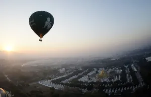 Ballooning Prints: This photo taken on February 5, 2014 shows a hot air balloon flying over a temple