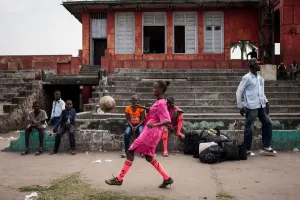 Child Prints: A player juggles before a match in Kinshasa on April 11, 2015. AFP PHOTO / FEDERICO SCOPPA