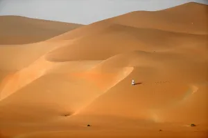 <b class=qtipBold><figcaption>Uae-Camel-Desert-Nature-Tourism</figcaption></b><br>Emirati men walk across the dunes in the Rimah desert, west of Al-Ain in the United Arab Emirates on February 27, 2017. / AFP PHOTO / KARIM SAHIB<br><em>© Copyright Agence France-Presse (AFP) - All Rights Reserved</em> Uae-Camel-Desert-Nature-Tourism
