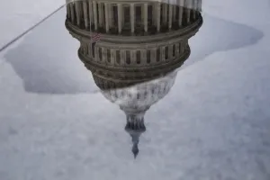 Prints of The National Capitol is reflected upside down in a puddle of water in Washington, DC on January 30, 2017. / AFP PHOTO / JIM WATSON USA Prints: Us-Politics-Capitol