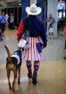 Prints of Texas Delegates Matthew Walbeck with his dog on the first day of the Republican National Convention on July 18, 2016 at the Quicken Loans Arena in Cleveland, Ohio USA Prints: Us-Republicans-Flag-Dog