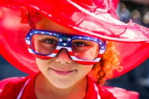 Prints of A girl wearing glasses in the american colors celebrating the 4th of July. AFP PHOTO USA Prints: USA- 4th of July -Independence Day celebrations