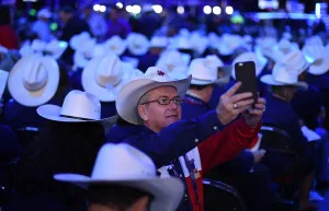 Prints of Texas Delegate Buddy Pilgrim takes photos on the first day of the Republican National Convention on July 18, 2016 at the Quicken Loans Arena in Cleveland, Ohio. / AFP PHOTO / TIMOTHY A. CLARY USA Prints: Usa-Republican-Texas - Hats