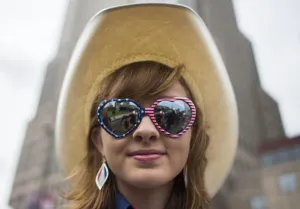 Prints of A Republican delegate poses for a photo as she waits to board a bus to the Quicken Loans Arena before the opening of the Republican National Convention on July 18, 2016 in Cleveland, Ohio USA Prints: Usa-Sunglasses - Hat