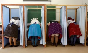 Women dressed in traditional Hungarian outfit prepare their votes in a polling station Women dressed in traditional Hungarian outfit prepare their votes in a polling station
